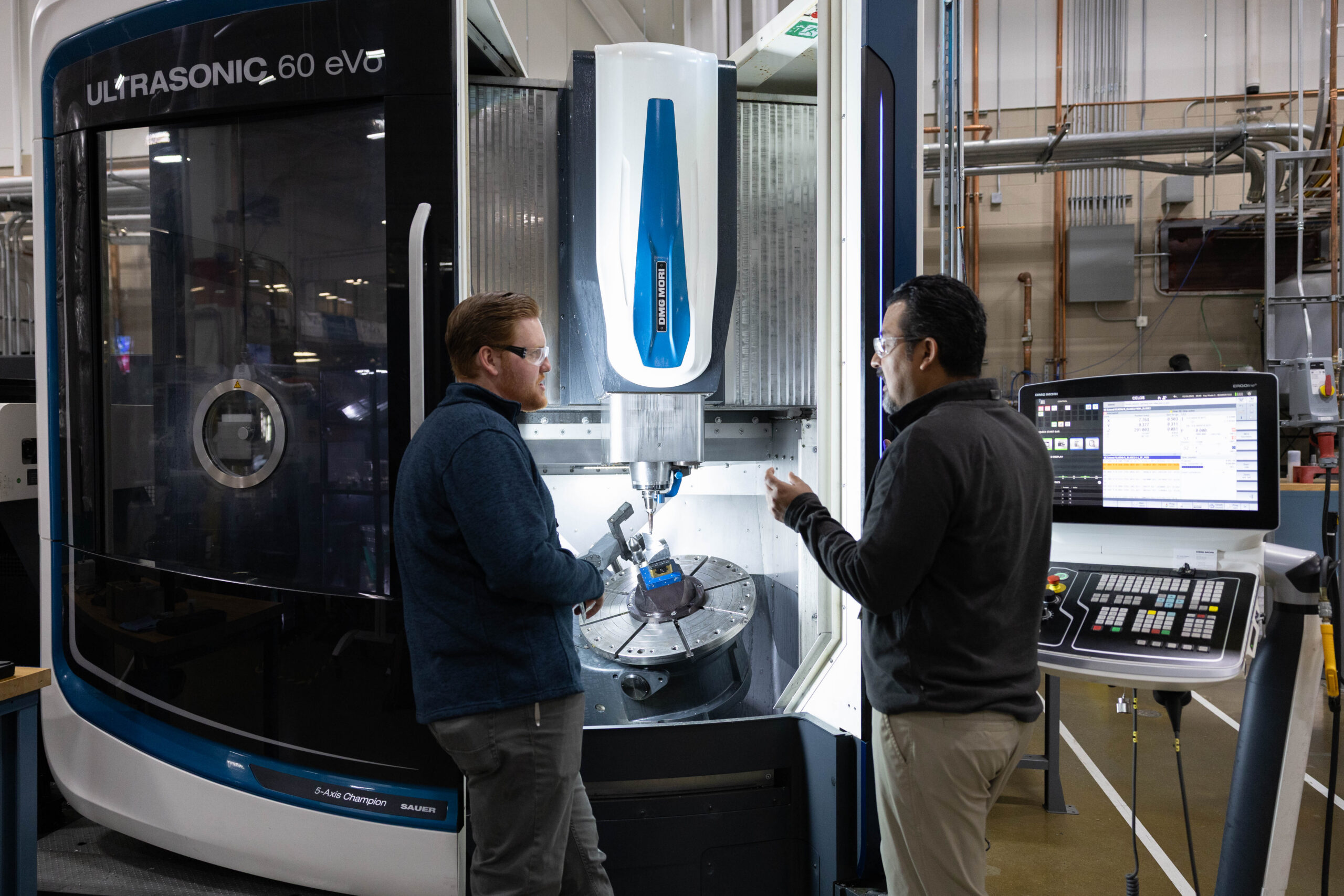 Greg Corson, left, R&D assistant, and David Olvera Trejo, R&D staff member in the in the advanced machining area at the Manufacturing Demonstration Facility April 2, 2025.